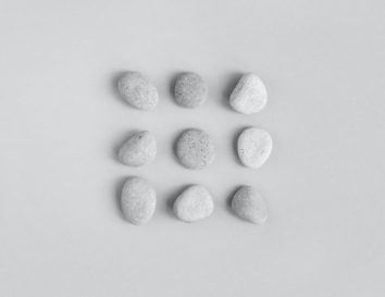 pebble-stones-light-gray-background-minimal-design-flat-lay